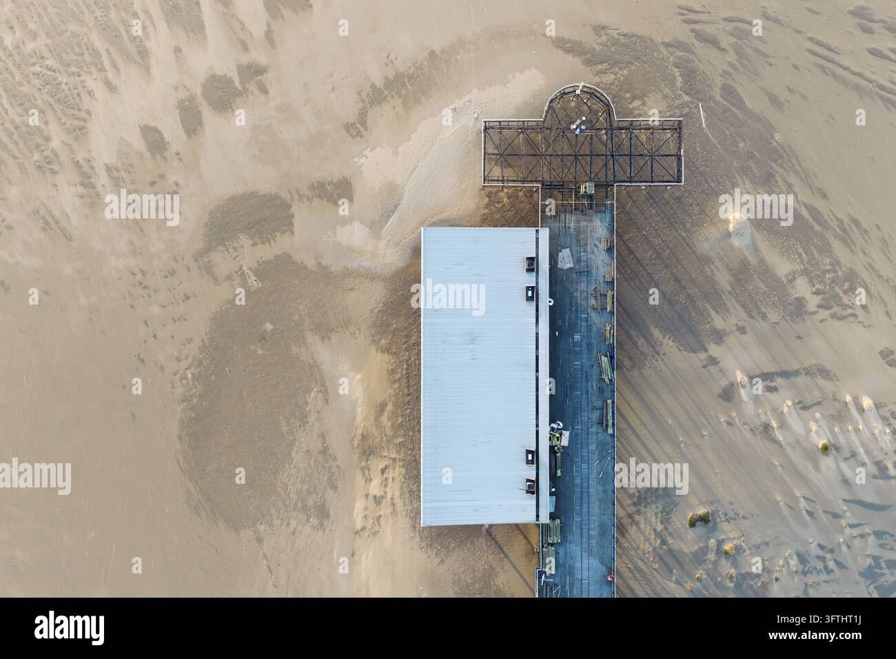 Aerial view of a pier structure with a metal frame and a roofed section ...