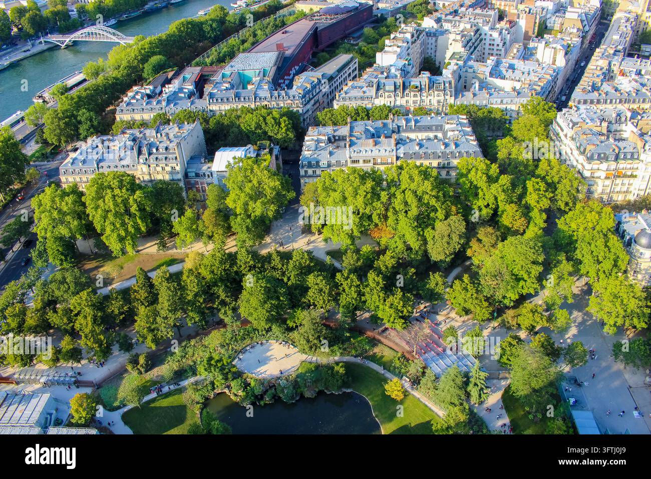 Paris, France - 31 July 2019: View of the lush green park with a small ...