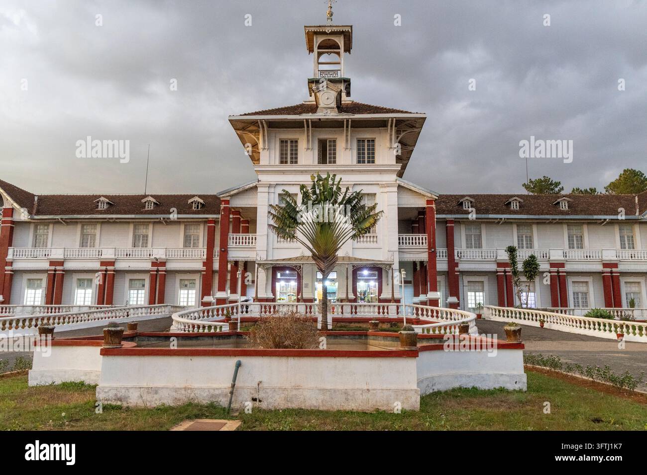 Grand colonial building with a clock tower and balustrades beside a ...