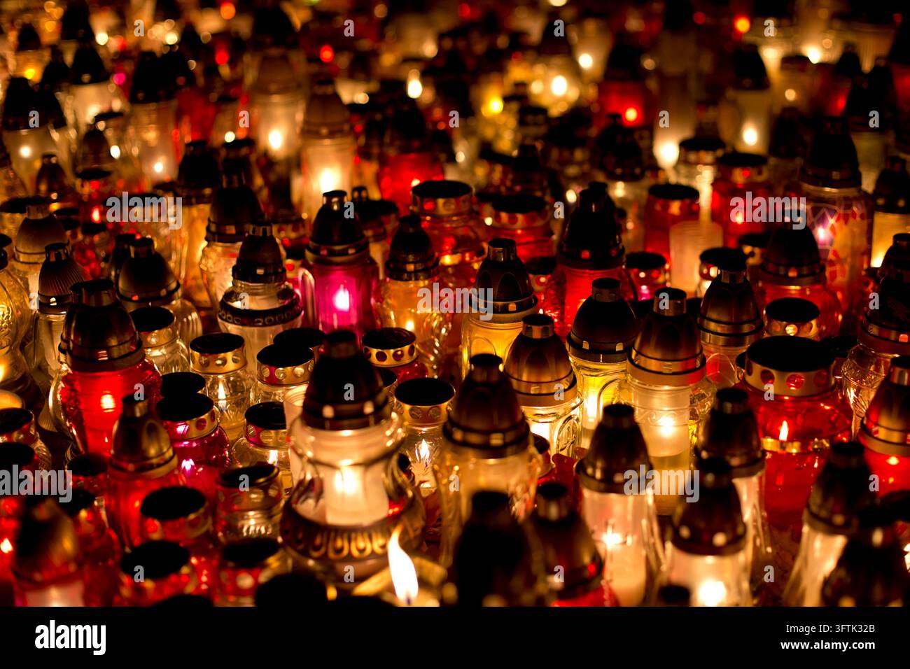 Lit memorial candles at a cemetery on All Souls' Day Stock Photo - Alamy