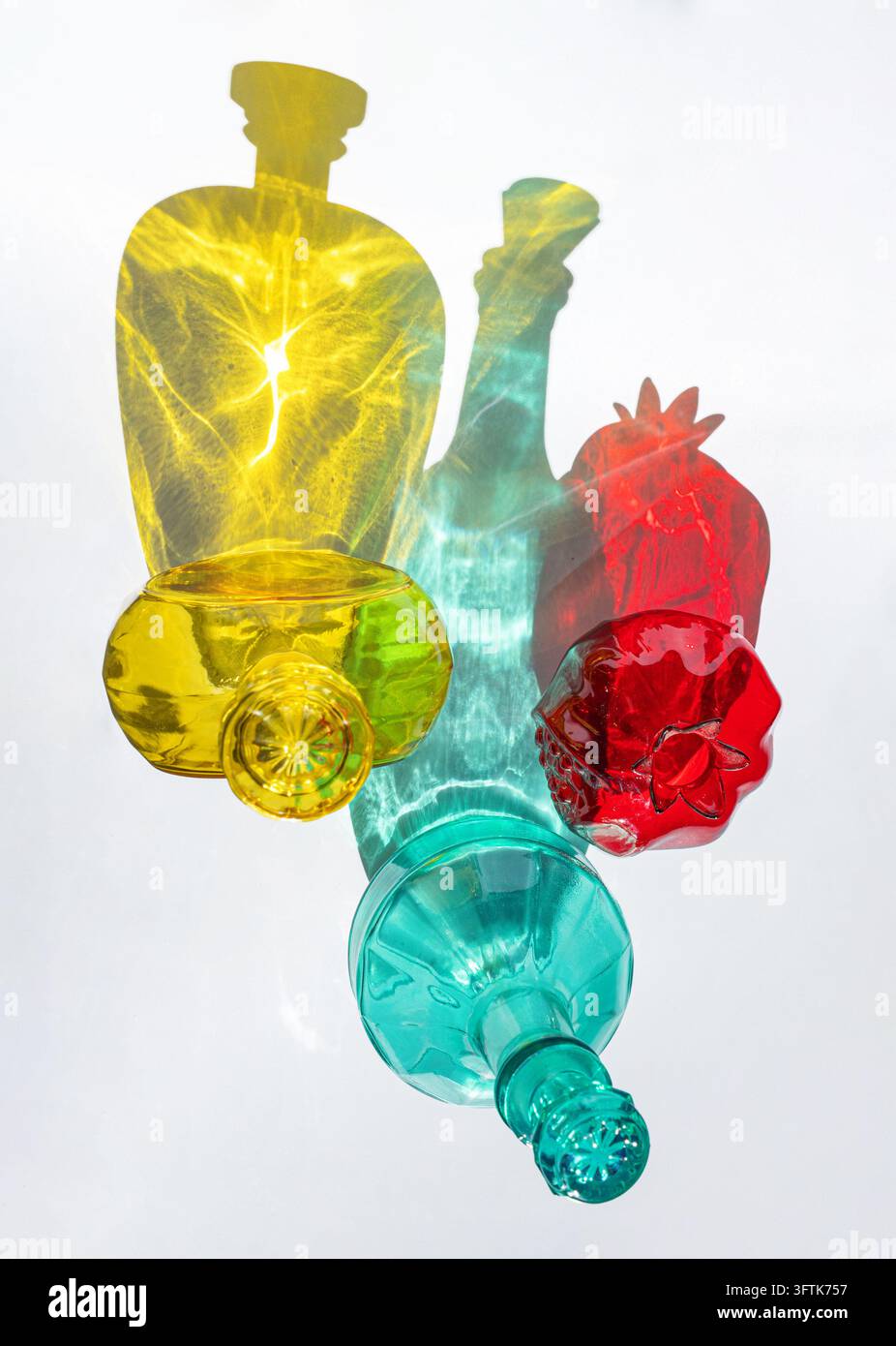 Colorful Glass Bottles with Abstract Light Patterns and Shadows Stock Photo