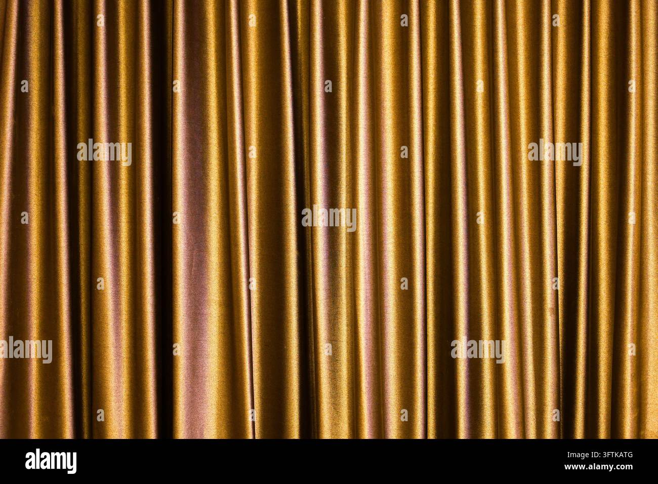 A golden vertical fabric folds create rich metallic texture with ...
