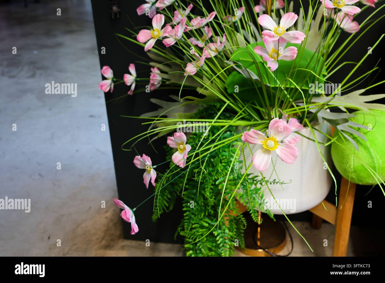 Using A Pink Flower A pink cosmos flower arrangement with green fern, grass, and round leaf ...