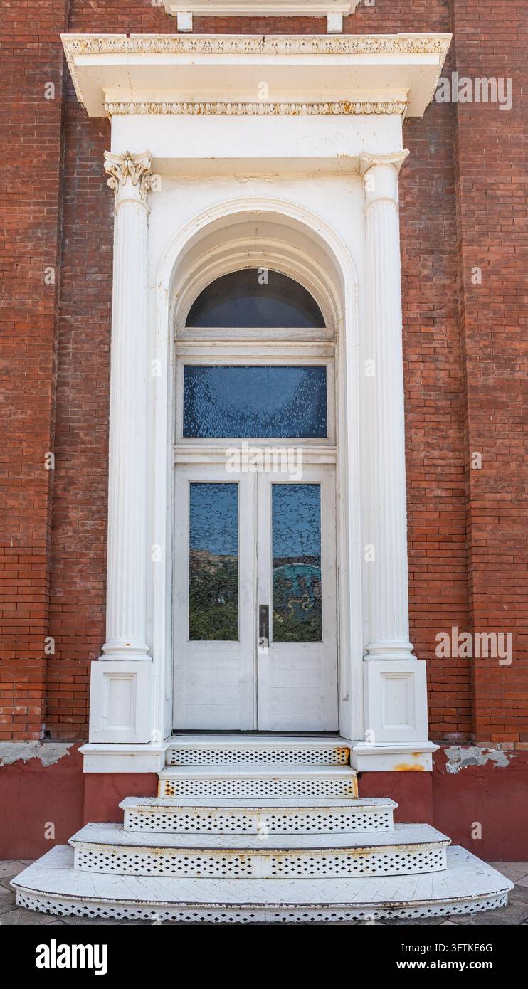 Historic building entrance featuring white double doors, fluted columns ...