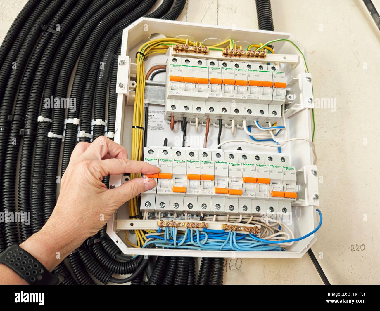 Kirov, Russia - July 11, 2026: Hand operating a circuit breaker in an ...
