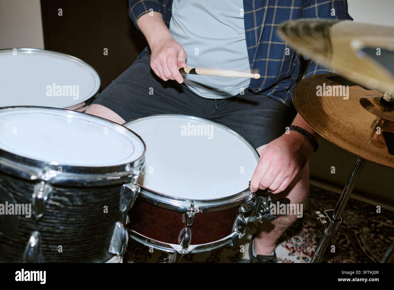 Cropped View of Man Playing Drums during Music Rehearsal Stock Photo