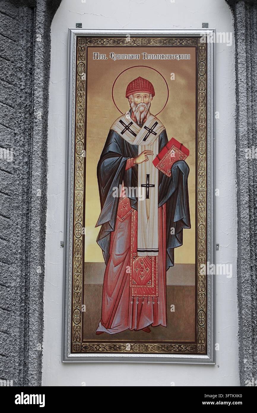 An Orthodox icon of Saint Spyridon of Trimython, framed on a white wall ...