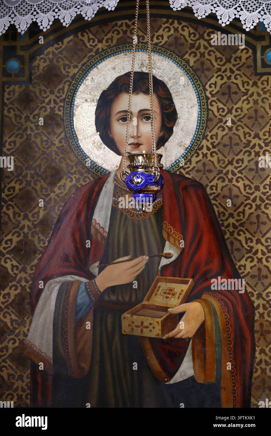 Icon of Saint Panteleimon holding a medicine box and a spoon, in front ...