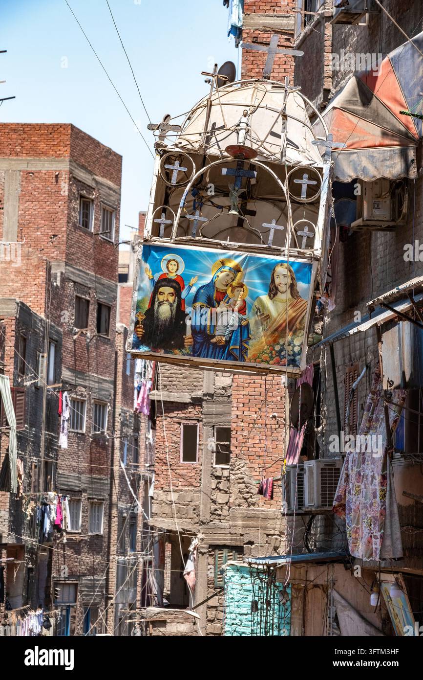 A suspended chapel adorned with religious icons overlooks a narrow ...