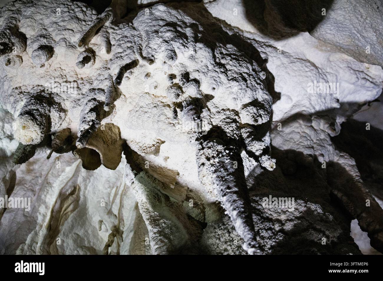 Textured mineral formations inside a natural cave Stock Photo