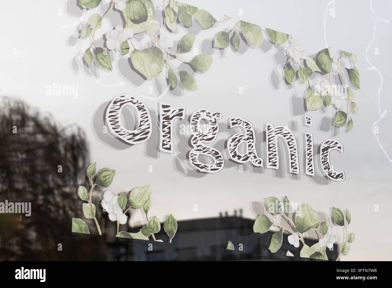 Organic decal sign with green leaf border on a clear shop window Stock ...