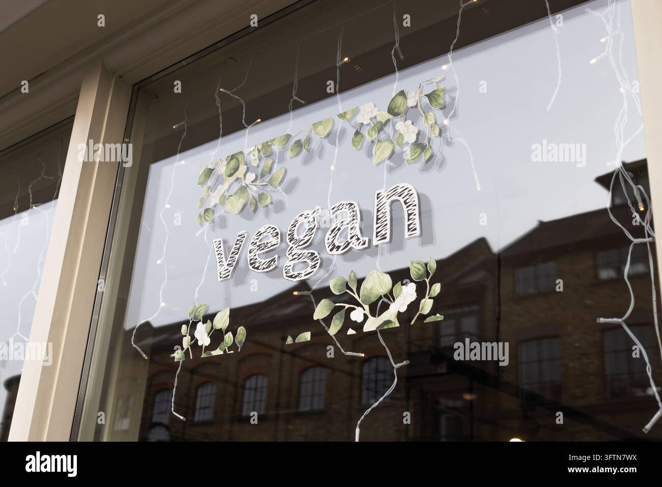 Vegan sign with decorative leaves in a glass shop window Stock Photo ...