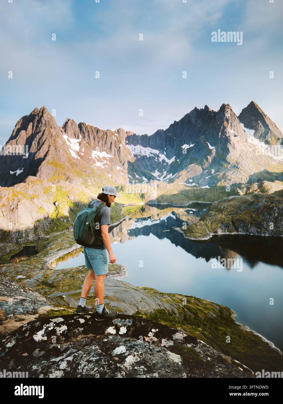 Man tourist backpacking in Lofoten islands hiking travel alone in ...