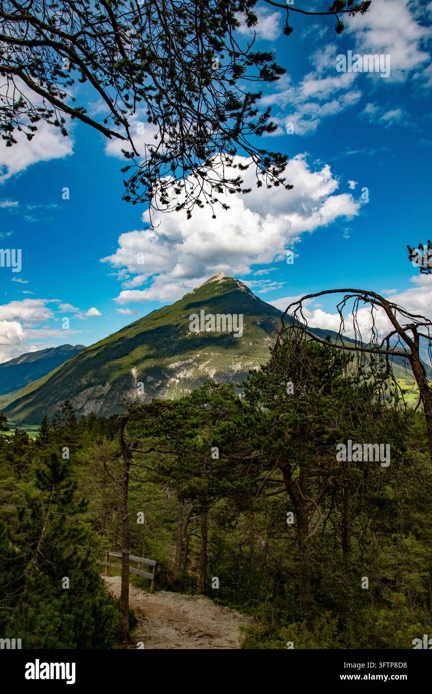View of the mountain landscape near Konigssee with a dirt path winding ...