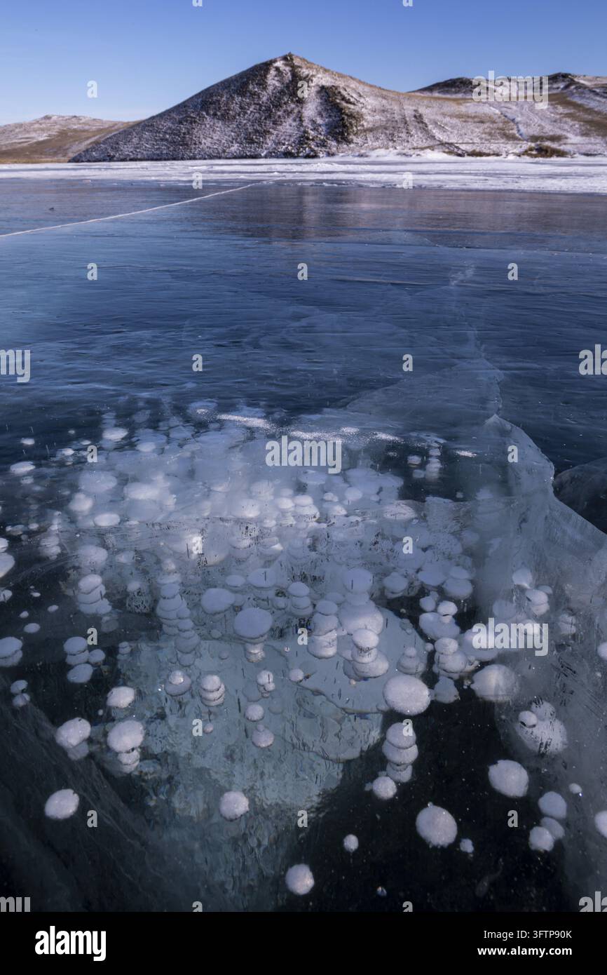 Mathane Ice View of methane bubbles trapped in the thick, clear ice of Lake Baikal ...