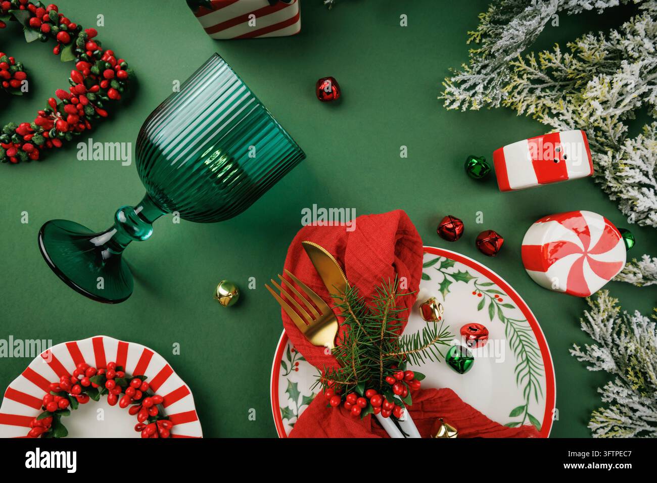 Overhead Christmas composition with festive tableware, green goblet and ...