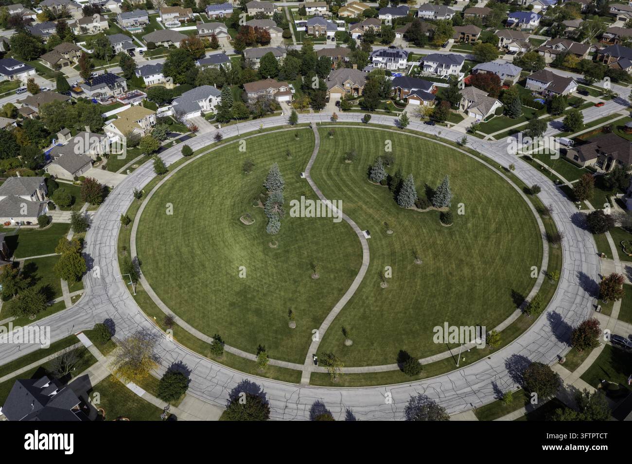 Aerial view of a circular park with a winding path in a residential ...
