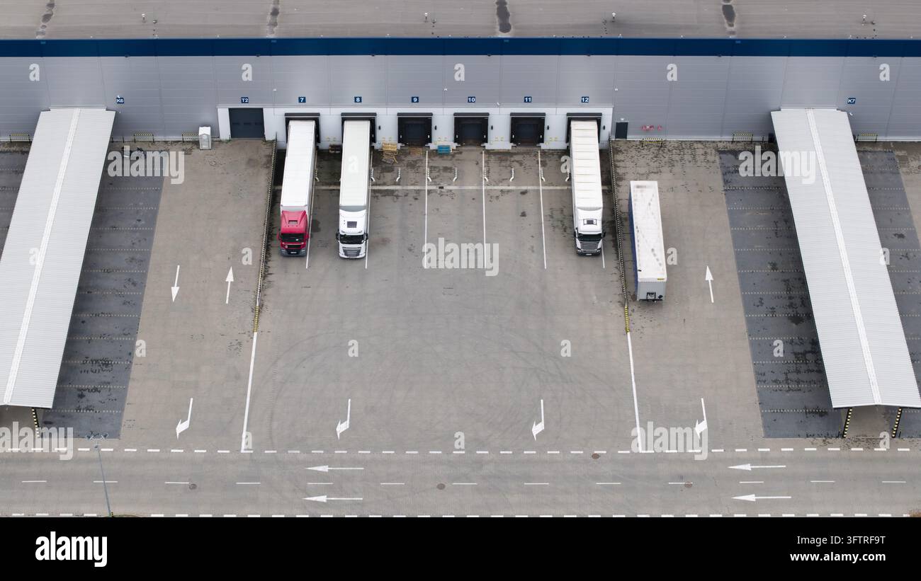 Aerial view of a logistics warehouse loading dock with semi-trucks ...