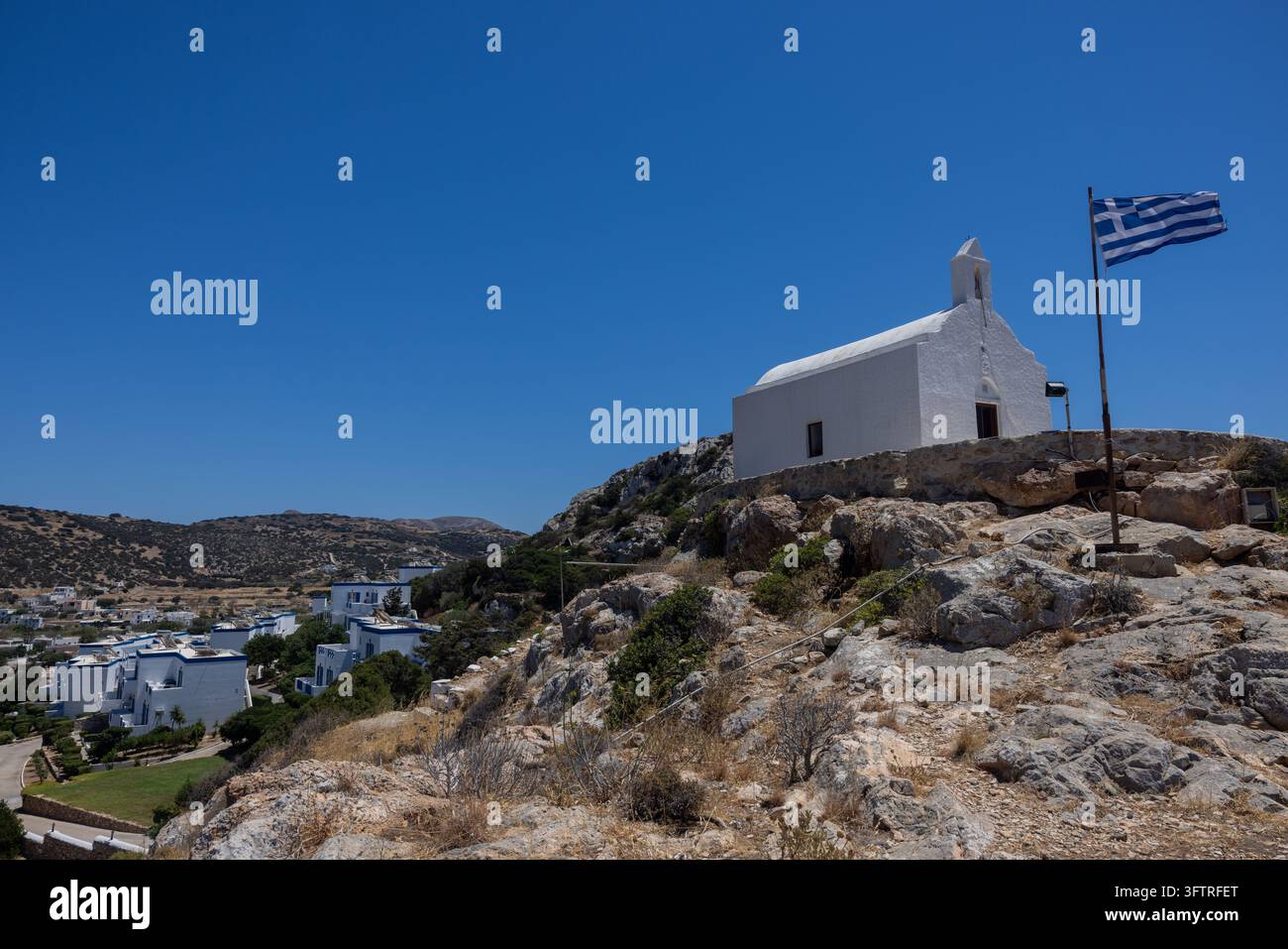 The small whitewashed Chapel of Agia Pakou overlooks the coastline of ...
