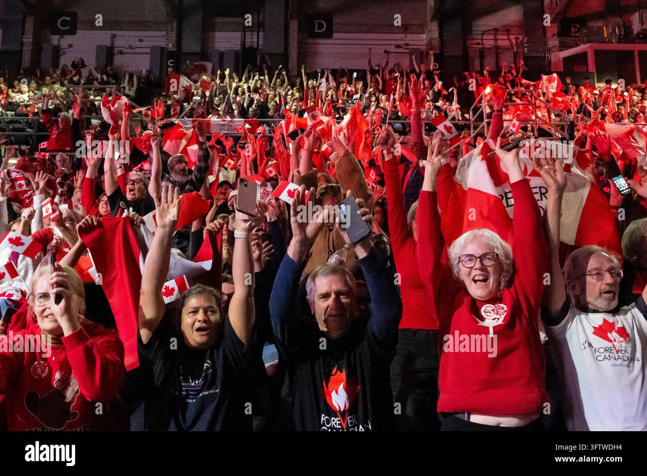 People cheer during a Forever Canadian rally in Edmonton, on Friday ...