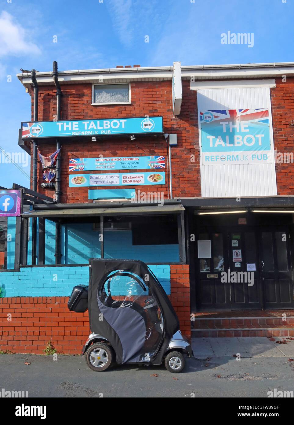 Mobility scooter outside The Talbot pub with Reform UK signs in Blackpool, Lancashire. Stock Photo