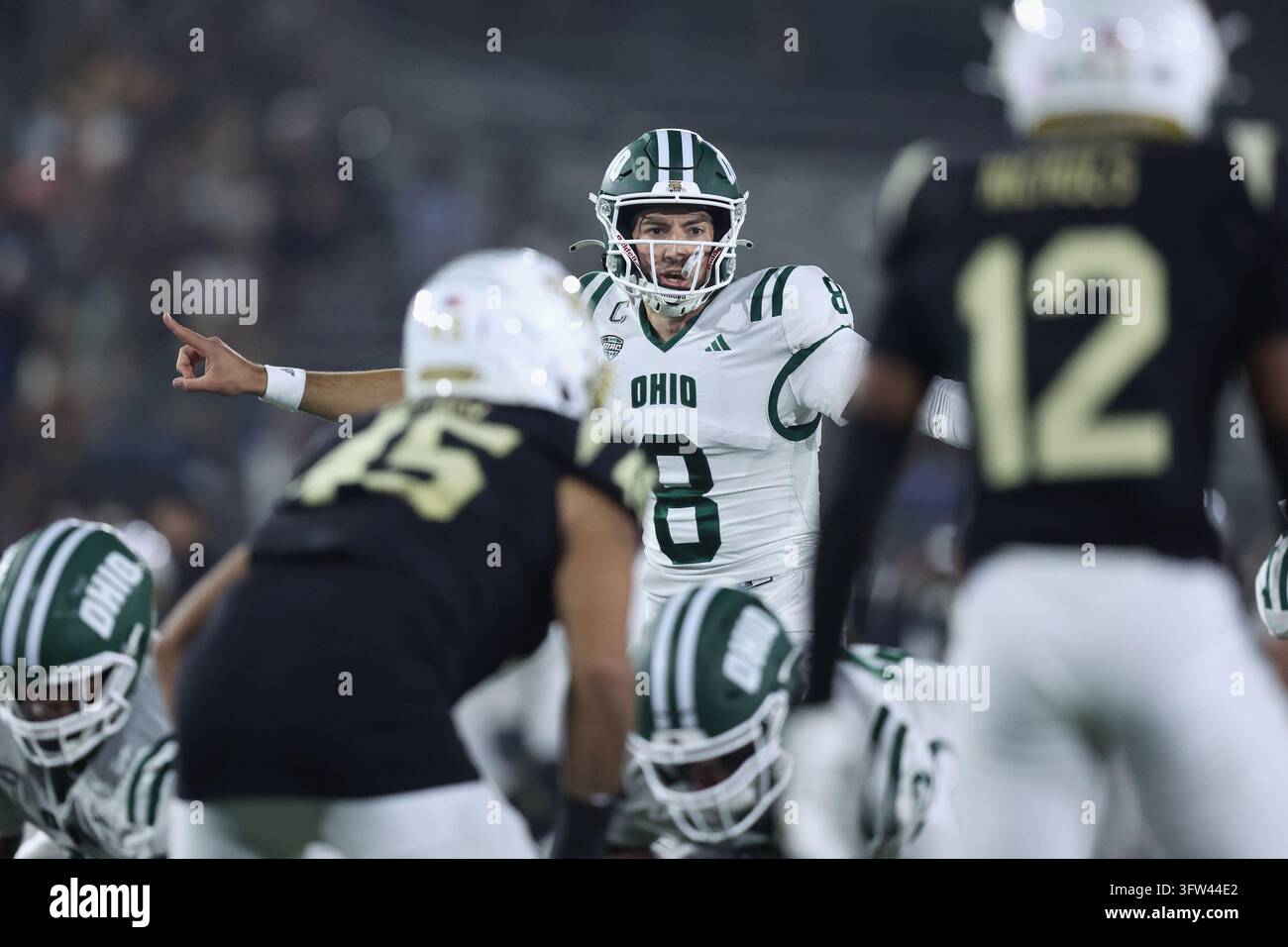 Ohio quarterback Nick Poulos (8) talks to teammates at the line of ...