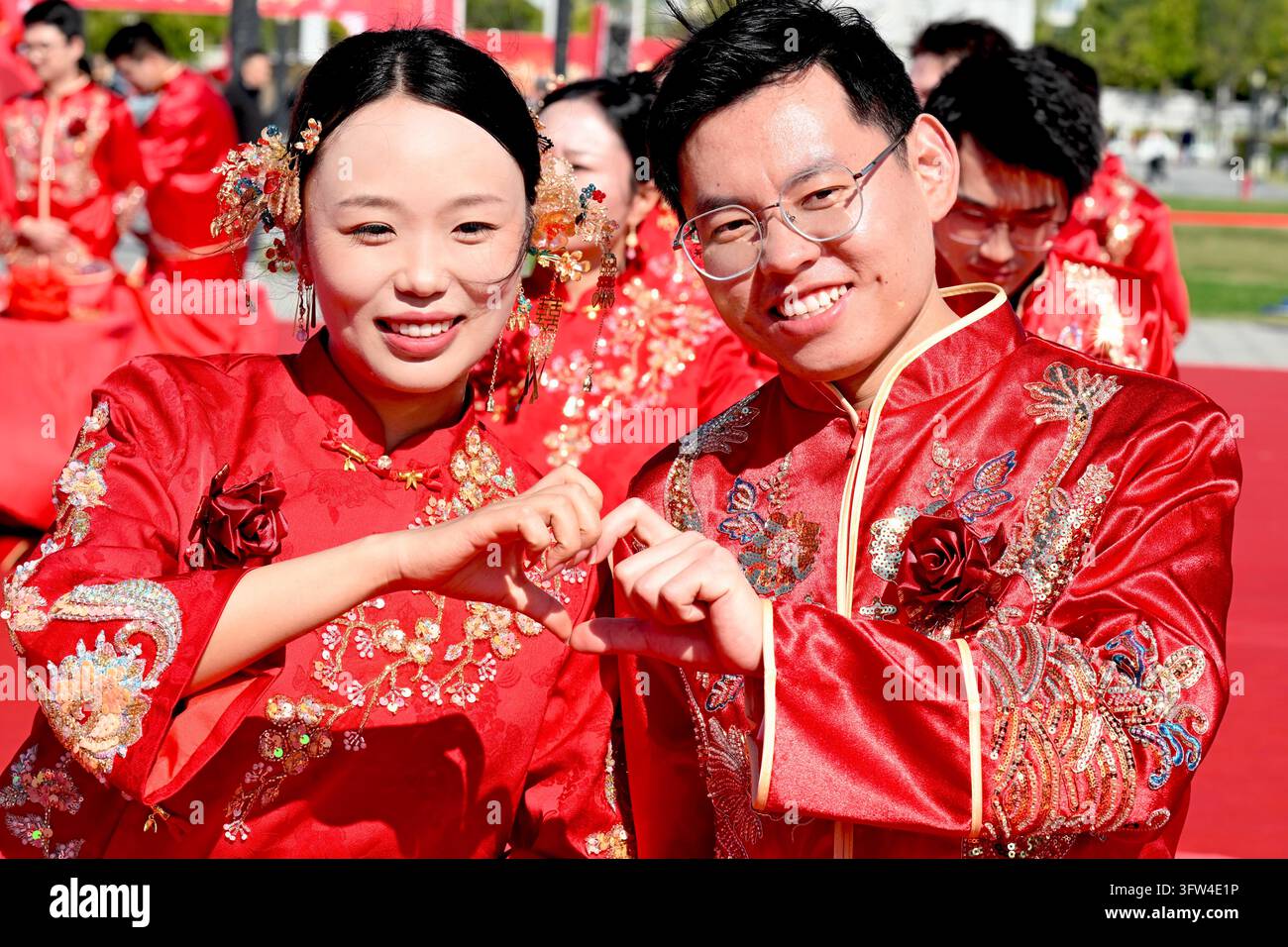 Couples participate in a collective wedding at the Gujing Group Jiushen ...