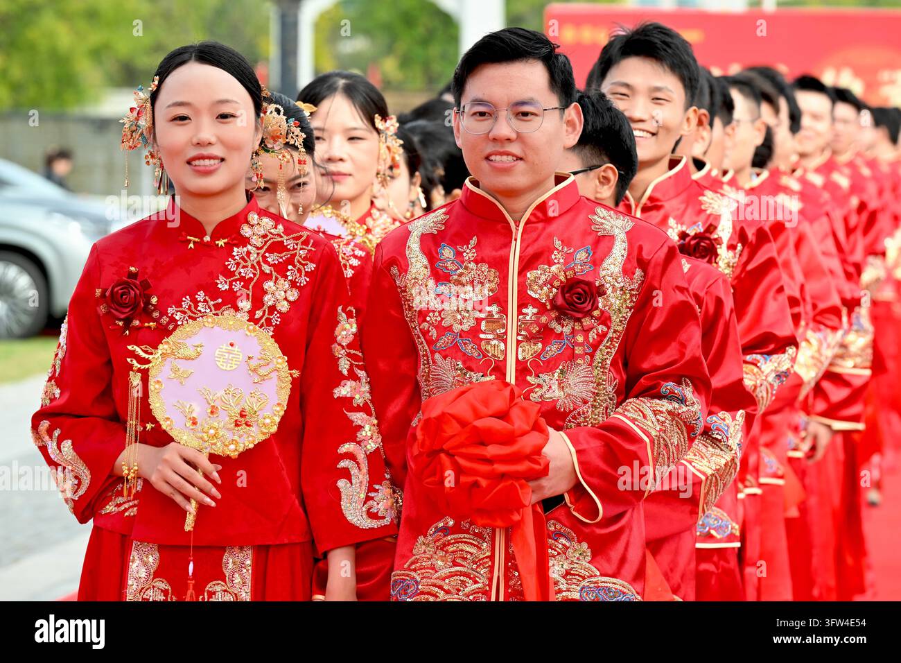 Couples participate in a collective wedding at the Gujing Group Jiushen ...