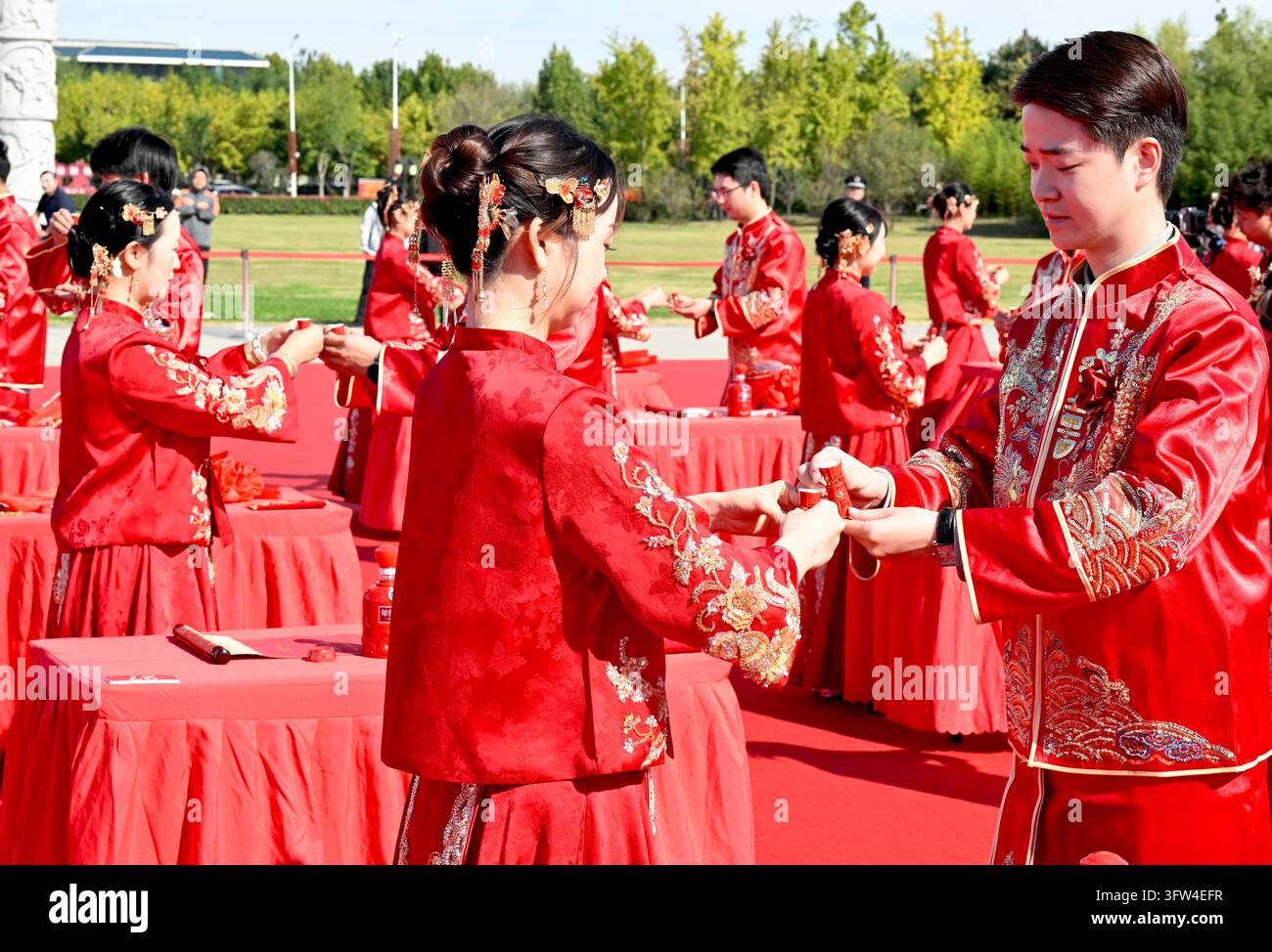 Couples participate in a collective wedding at the Gujing Group Jiushen ...