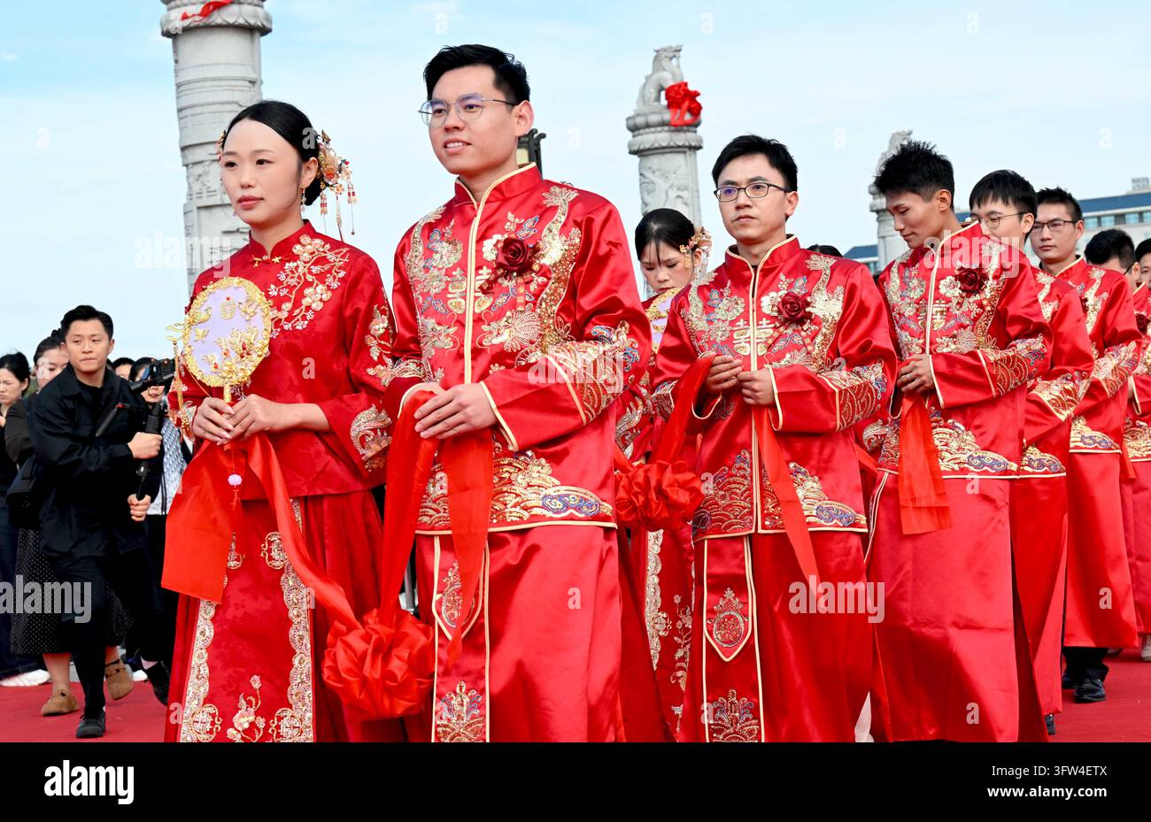 Couples participate in a collective wedding at the Gujing Group Jiushen ...