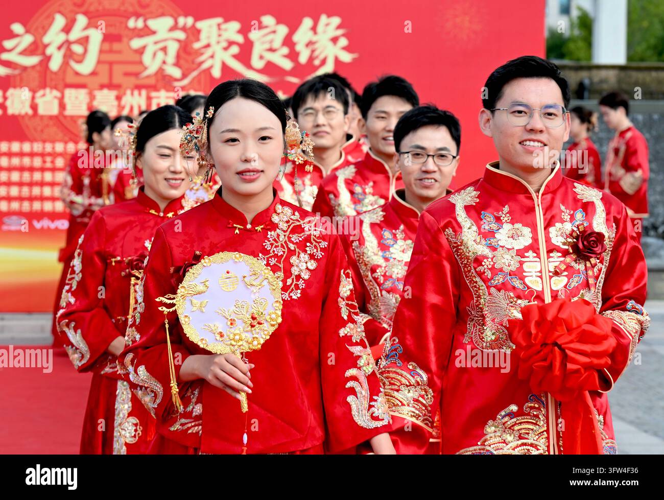 Couples participate in a collective wedding at the Gujing Group Jiushen ...