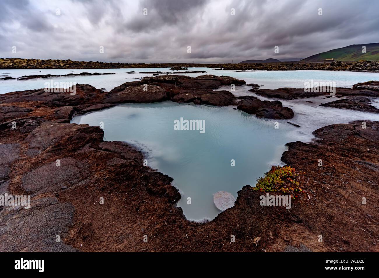 Isolated Volcano A horizontal view of an isolated circular thermal spring filled with ...