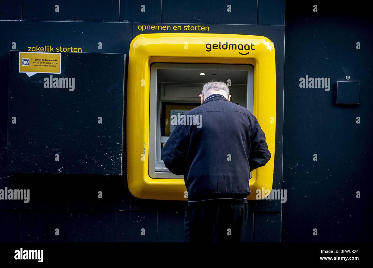 Readed R GOUDA - A customer withdraws money from a cash machine by using a card ...