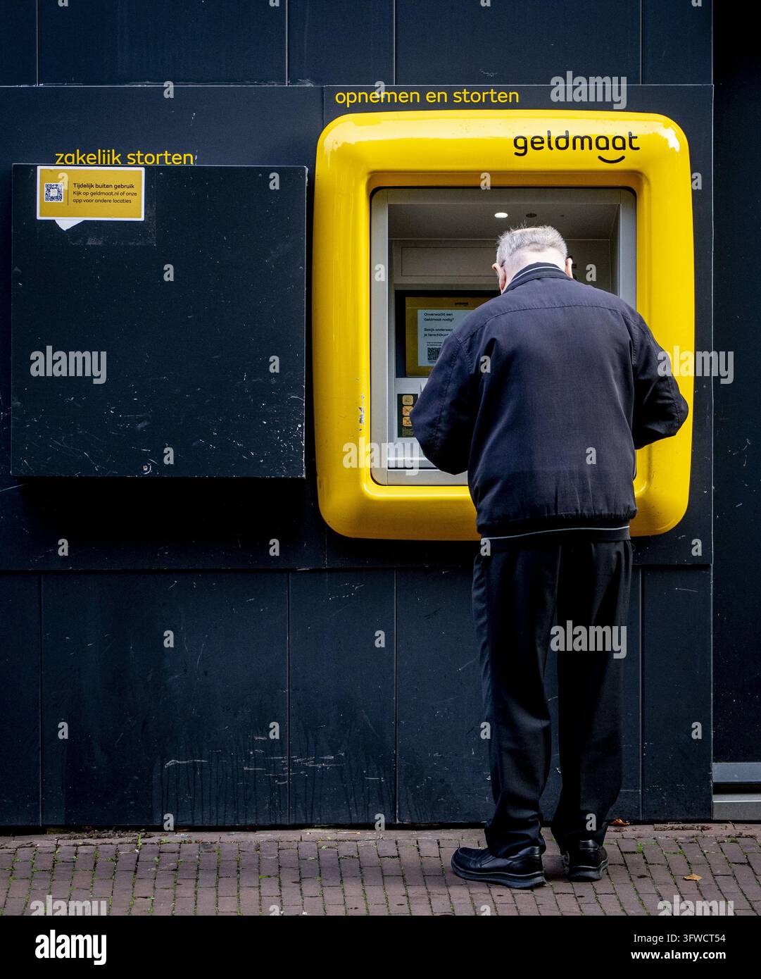 Readed R GOUDA - A customer withdraws money from a cash machine by using a card ...