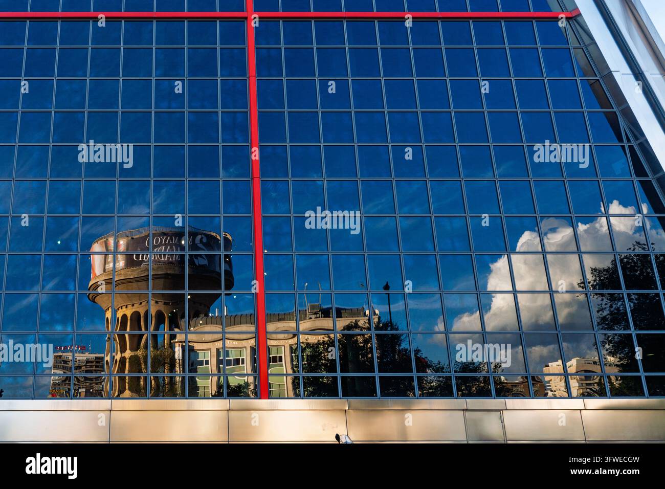 Cload Image Canal de Isabel II tower reflected on one of the KIO towers, with sky ...