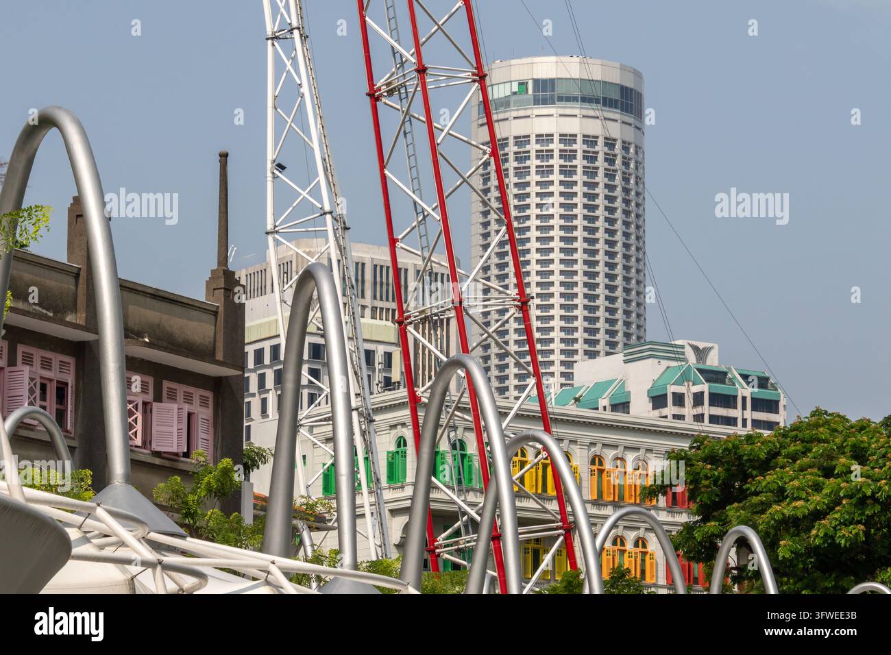 A vibrant city scene showcasing curved silver structures and amusement ...
