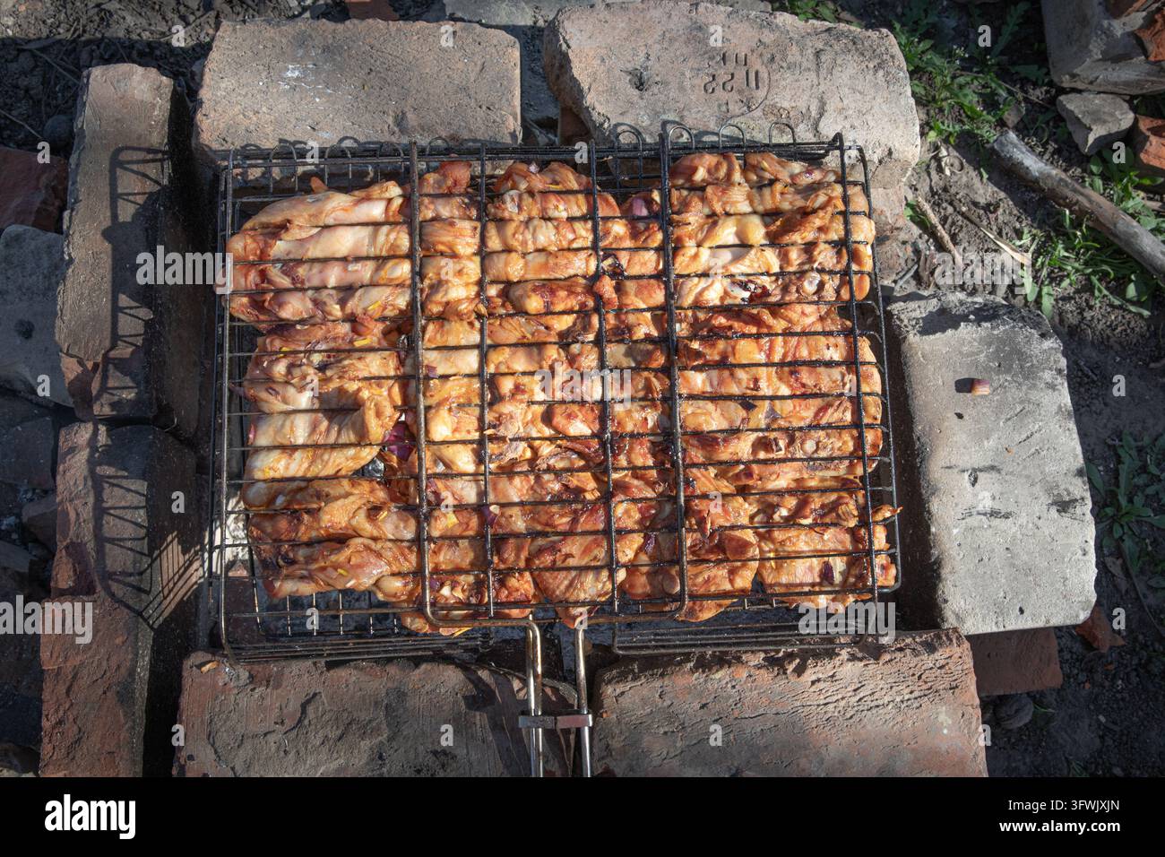 Marinated Chicken Pieces Cooking in Metal Grill Baskets over Charcoal ...