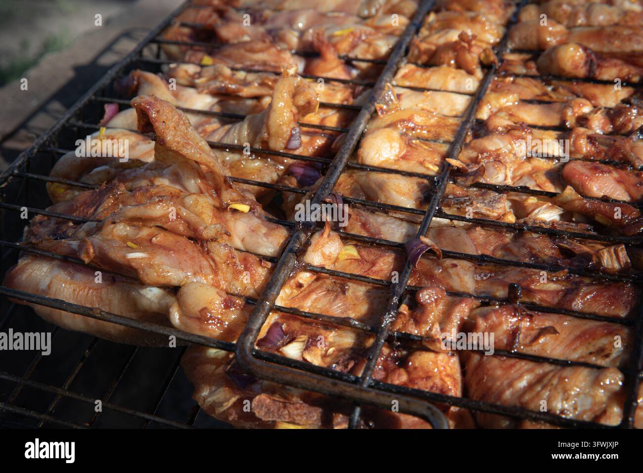 Marinated Chicken Pieces Cooking in Metal Grill Baskets over Charcoal ...