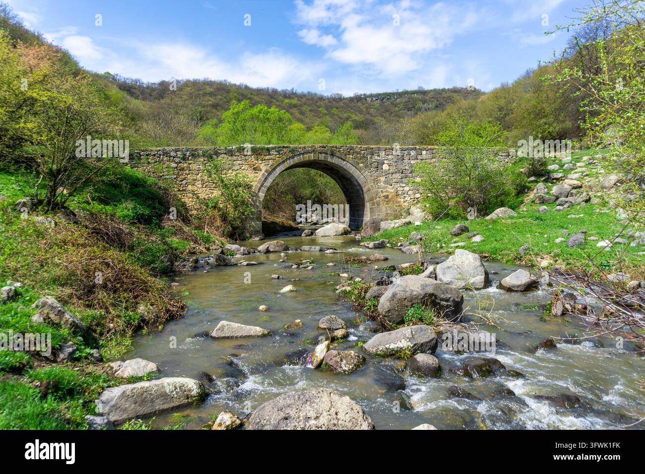 Medieval stone bridge over the river leading to the medieval town of ...