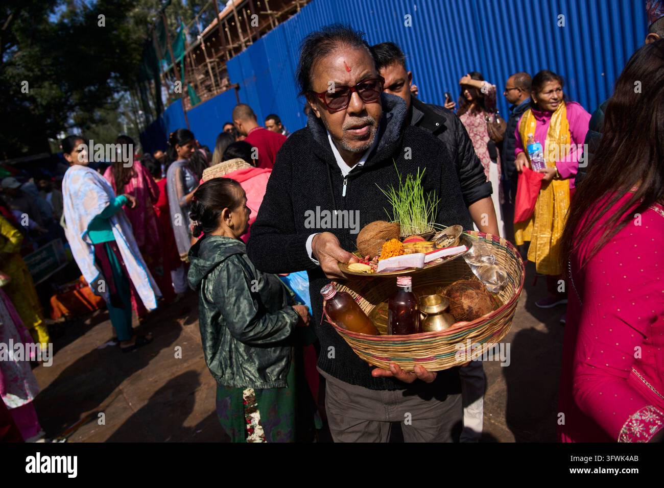 A devotee arrives carrying essential items for rituals during Nawami ...