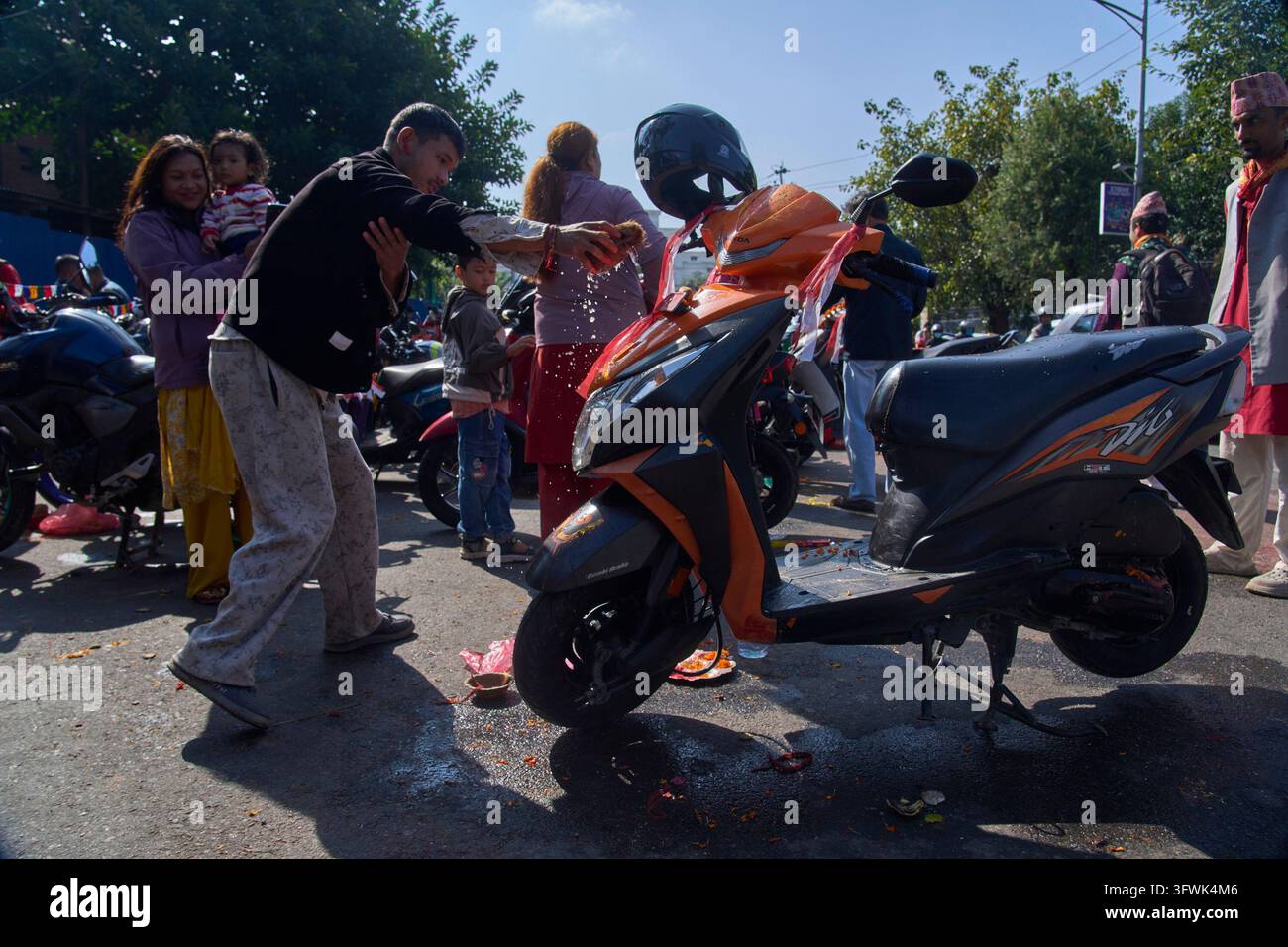 A devotee performs rituals for his scooter during Nawami, the ninth day ...