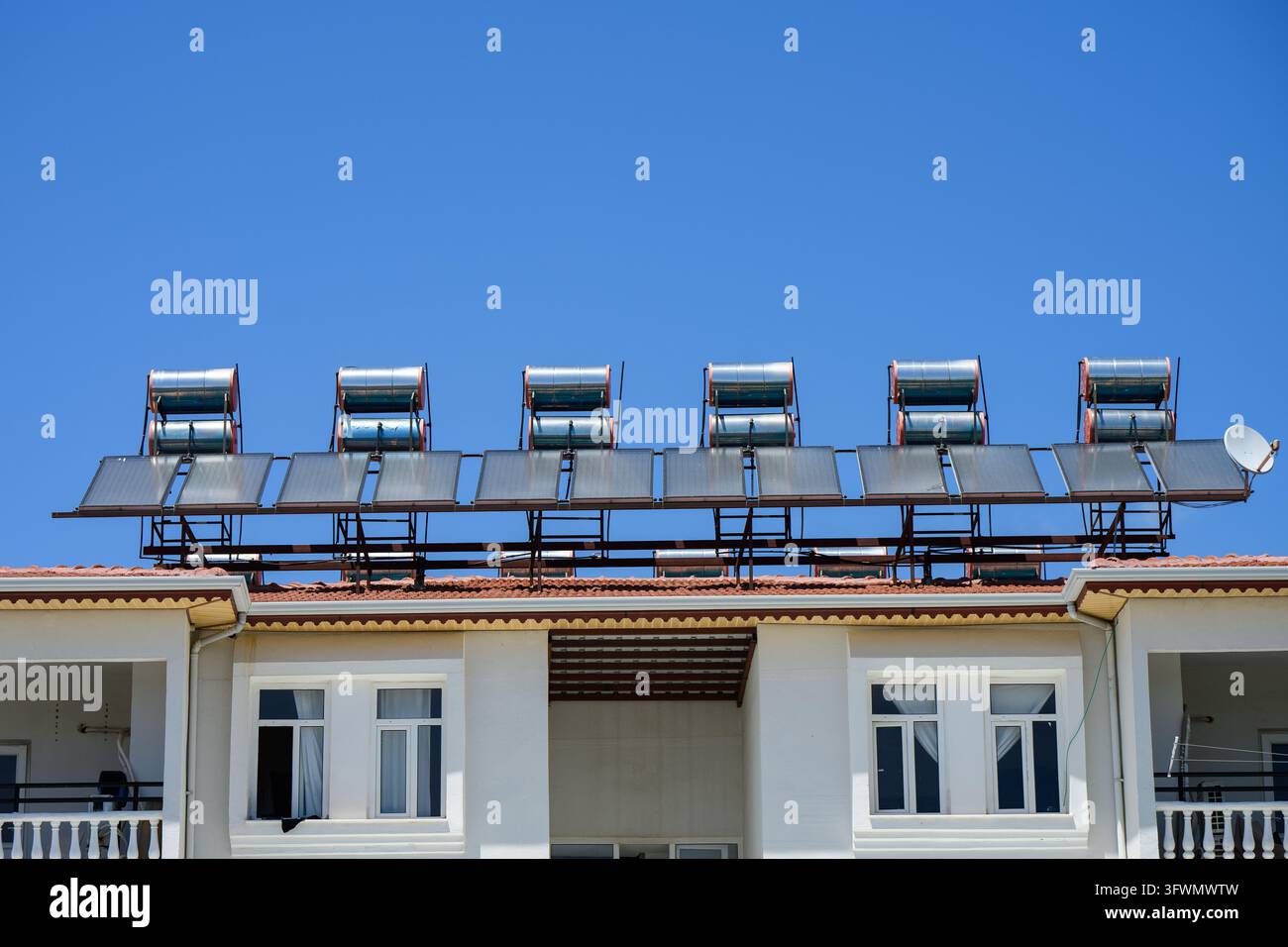 Solar water heater boilers and panels installation on hotel roof close ...