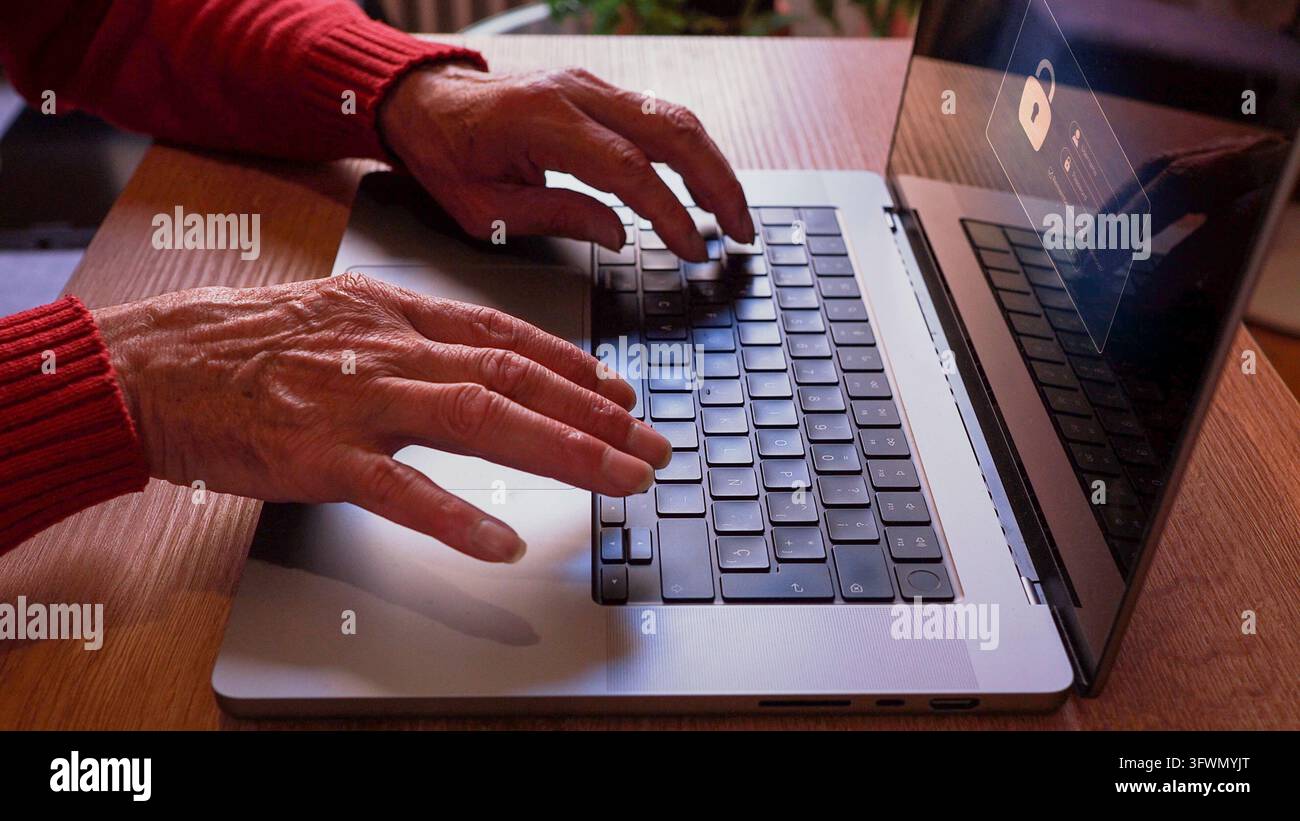 Senior person using a laptop with a cybersecurity lock icon on screen ...
