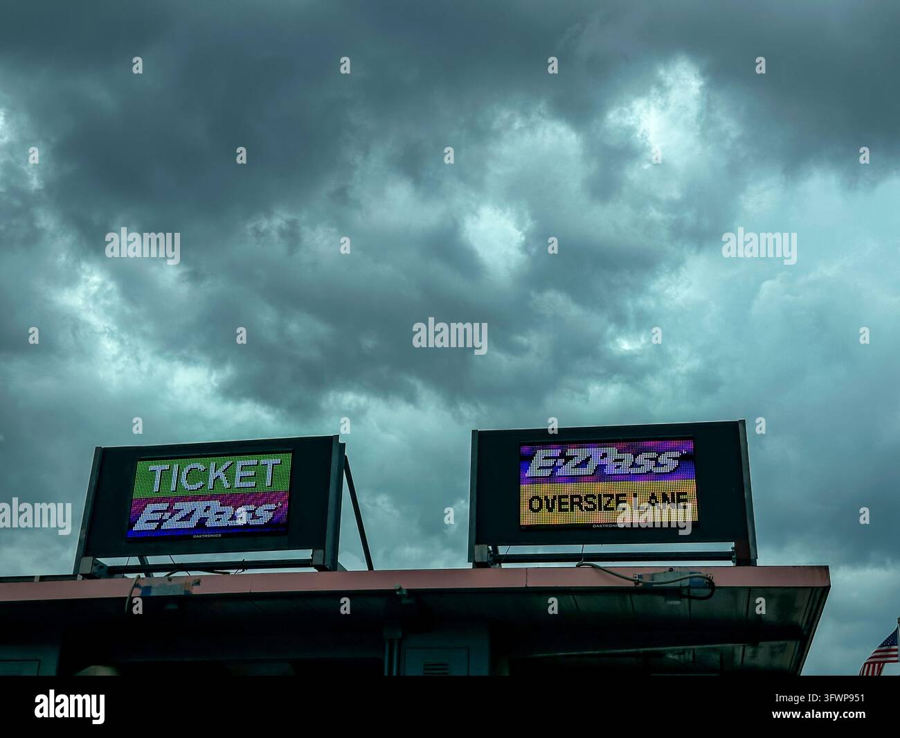 E-ZPass Oversize Lane Electronic Toll Booth Sign Under Stormy Sky. Chicago, IL USA - June 3, 2026 - Smartphone Captured Stock Image