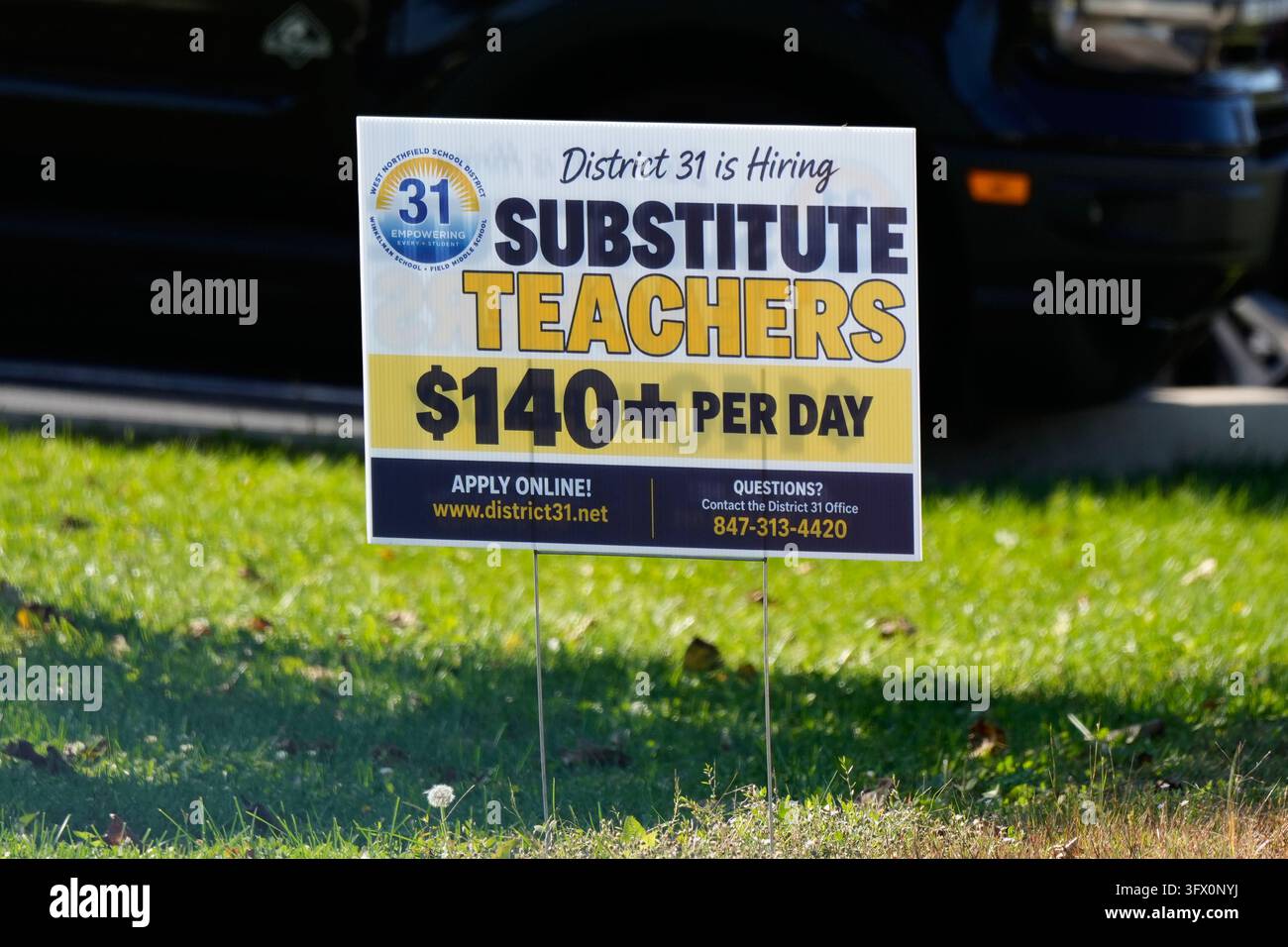 A hiring sign is displayed in Northbrook, Ill., Tuesday, Oct. 20, 2026 ...