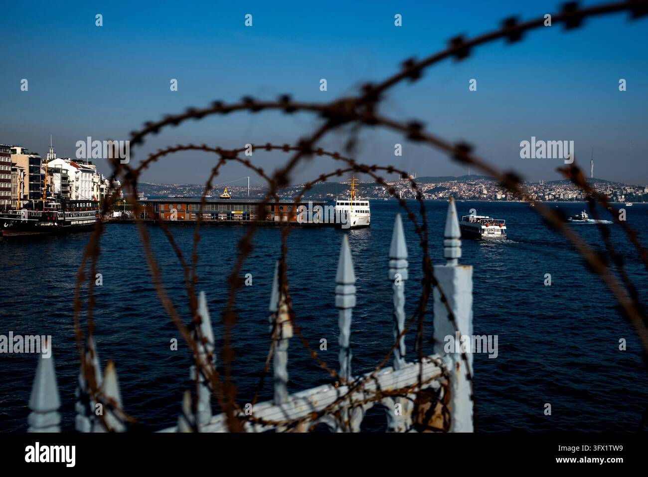 Wire Model Ship Istanbul, Turkey, October 21, 2026. Barbed wire frames a view of ships ...