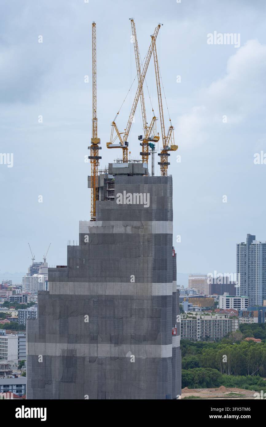 Building High Risers High rise building under construction with multiple tower cranes above ...