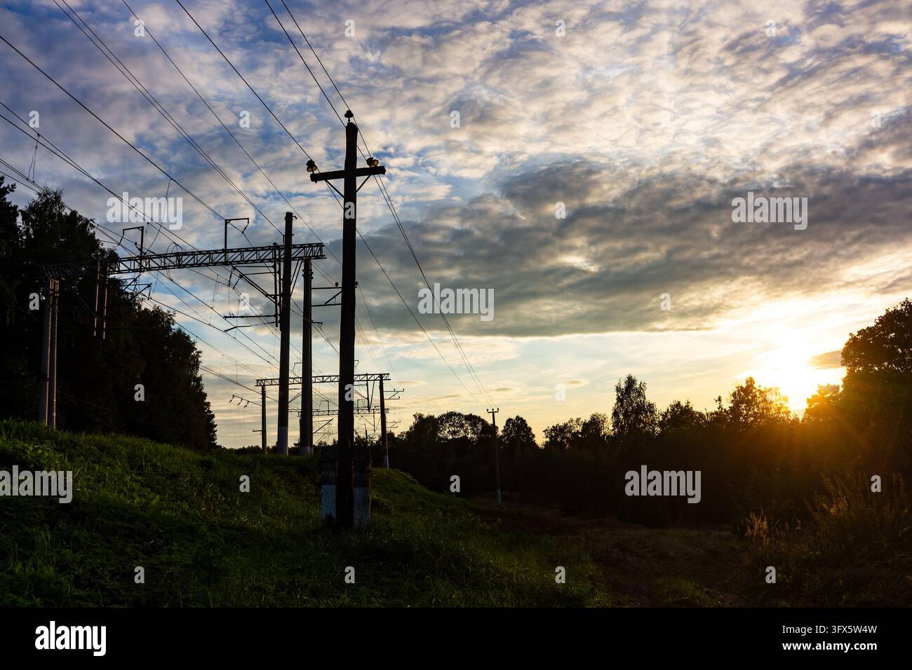 Sundet Line Model Silhouetted power transmission poles and overhead railway lines stand ...