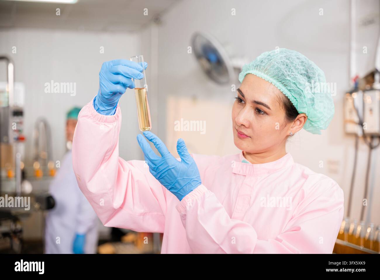 At juice beverage factory woman food engineer performs food and ...