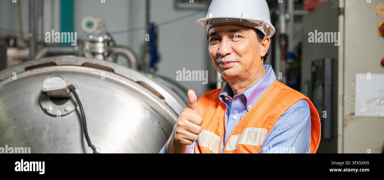 Asian engineer wearing hard hat and reflective vest giving thumbs up ...